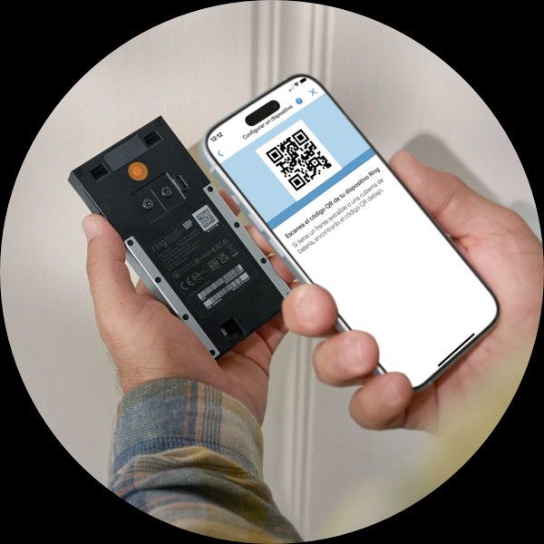 Un par de manos sostienen un teléfono y un Timbre con cámara inalámbrico Ring. La pantalla del teléfono muestra un código QR e indica al usuario que debe escanear el código QR de la parte posterior de su dispositivo.